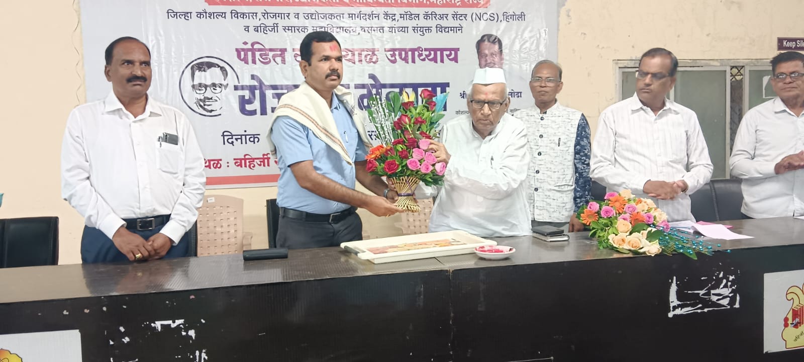 A light brown puppy standing on a white and tan woven pet bed.