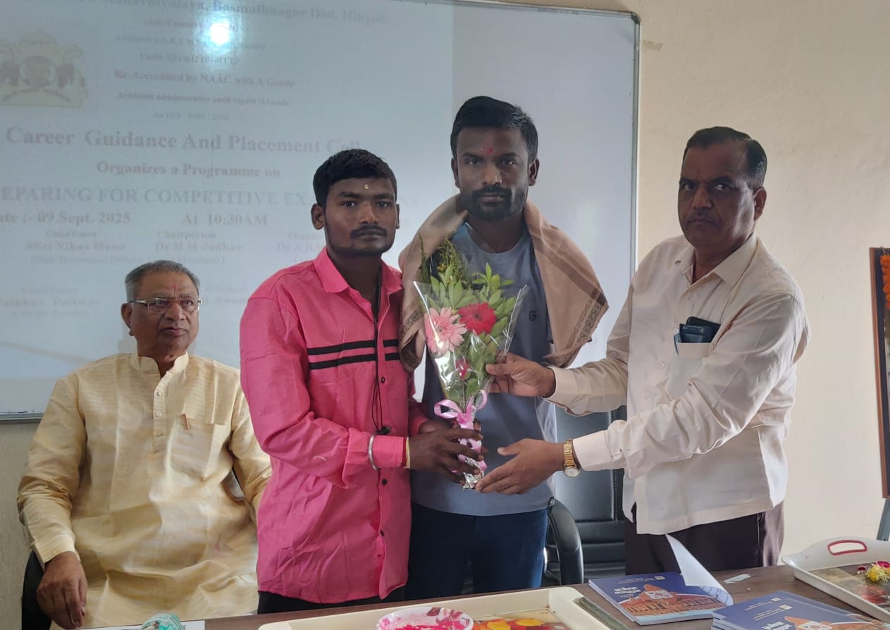 A light brown puppy standing on a white and tan woven pet bed.