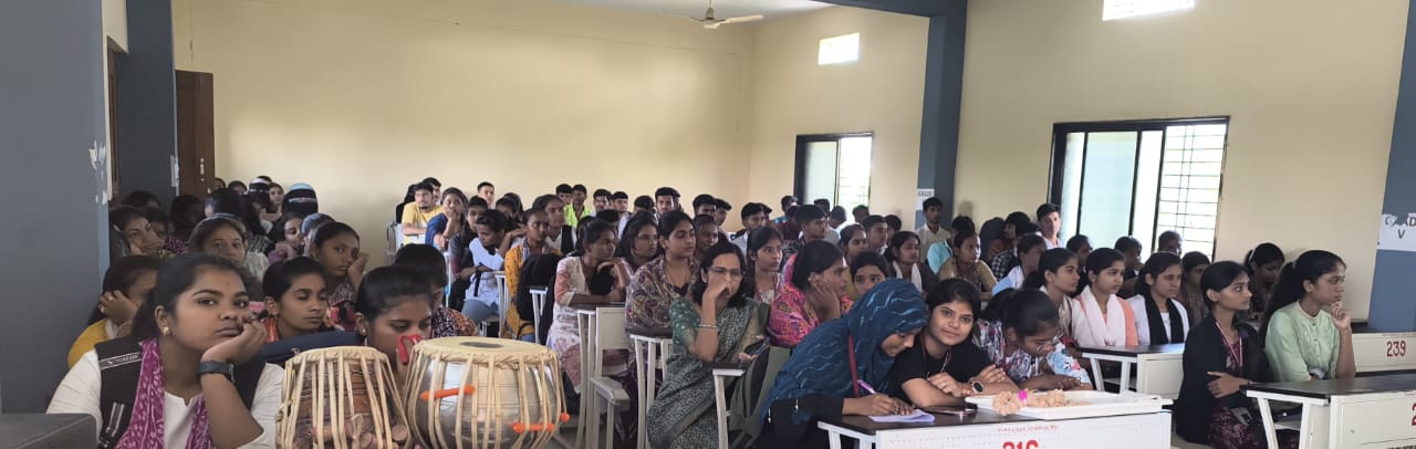 A light brown puppy standing on a white and tan woven pet bed.