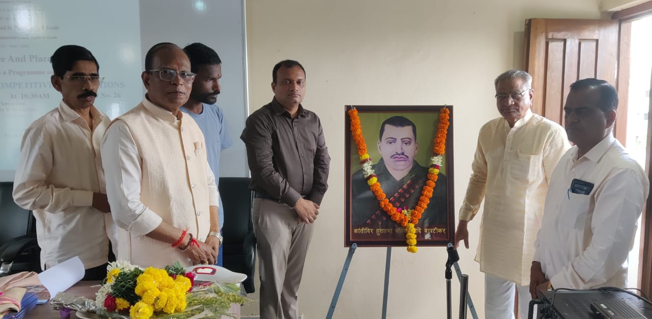A light brown puppy standing on a white and tan woven pet bed.